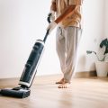 man-cleaning-floor-using-vacuum-cleaner-living-room-home-housekeeping-concept